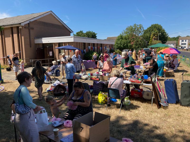 A crowd of families at a summer fete outside Emmanuel Church